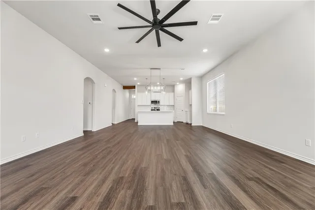 a view of a kitchen with a sink and wooden floor