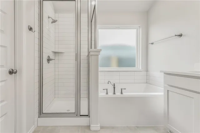a white bath tub sitting next to a shower