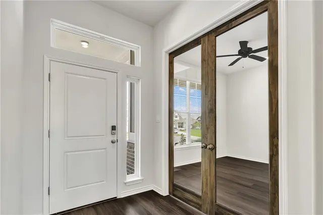 a view of a hallway with wooden floor and closet