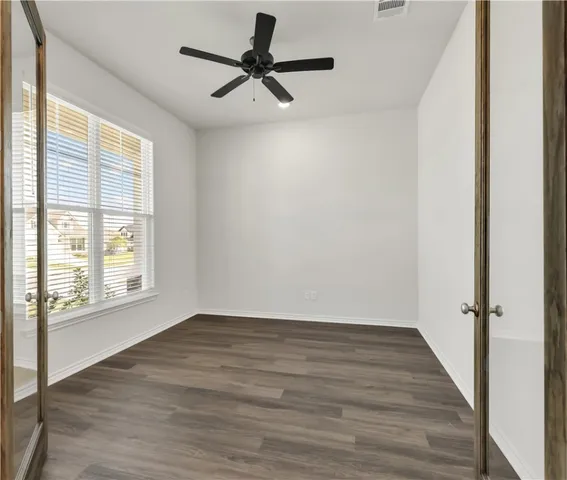 wooden floor in an empty room with a window