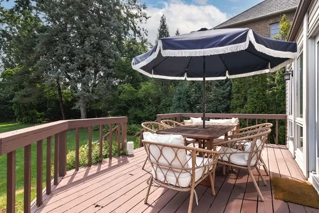a view of balcony with furniture and umbrella