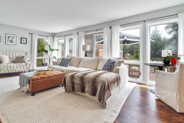 a spacious bedroom with a bed and glass walk in closet