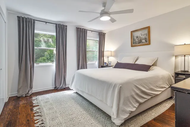 a bedroom with a bed and a large window