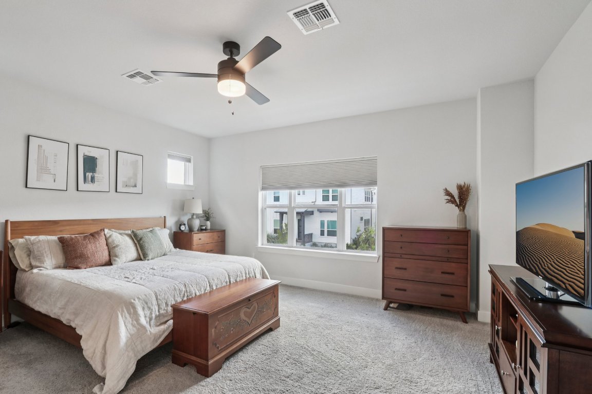 6001 McMurtry Street Austin, TX 78747 - Photo 11 of 26 a bedroom with a bed dresser and a window