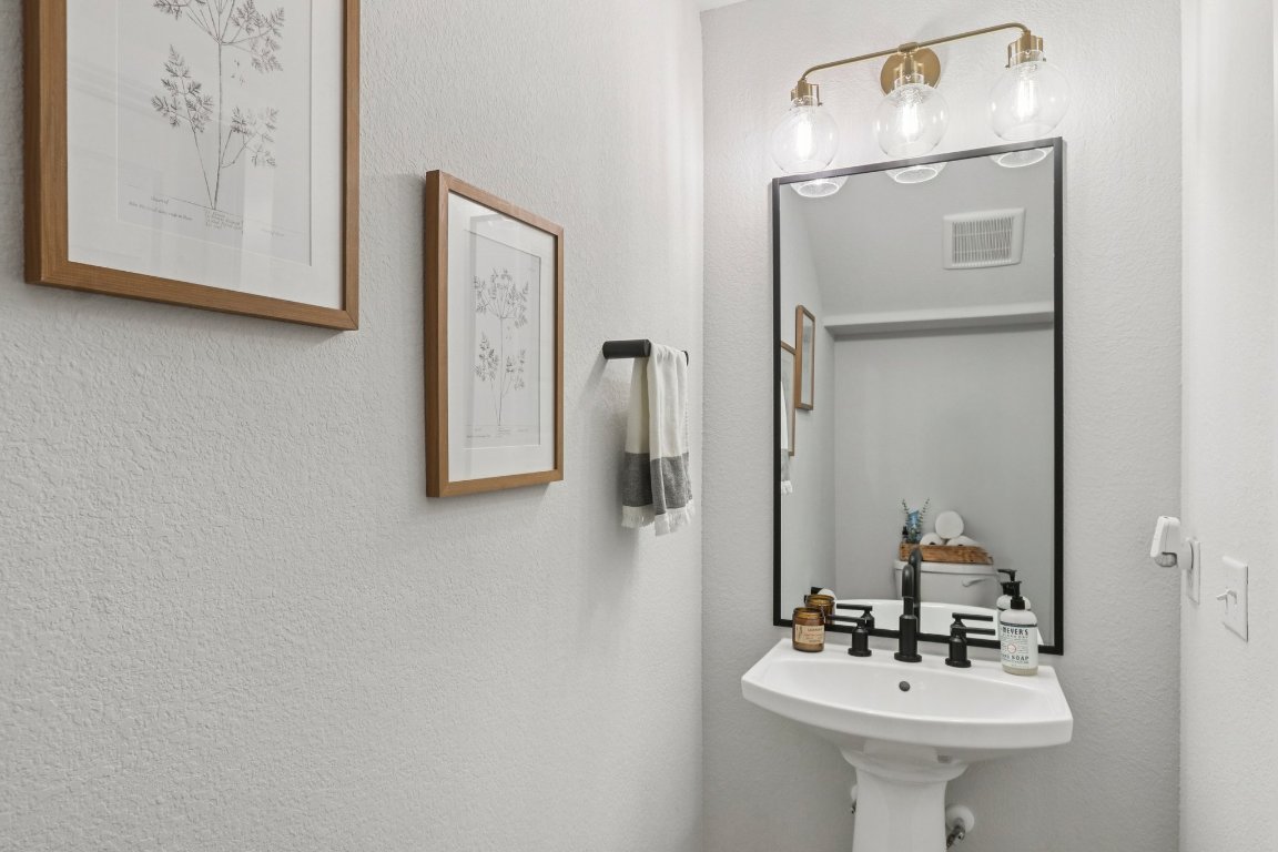 6001 McMurtry Street Austin, TX 78747 - Photo 17 of 26 a bathroom with a sink and a mirror