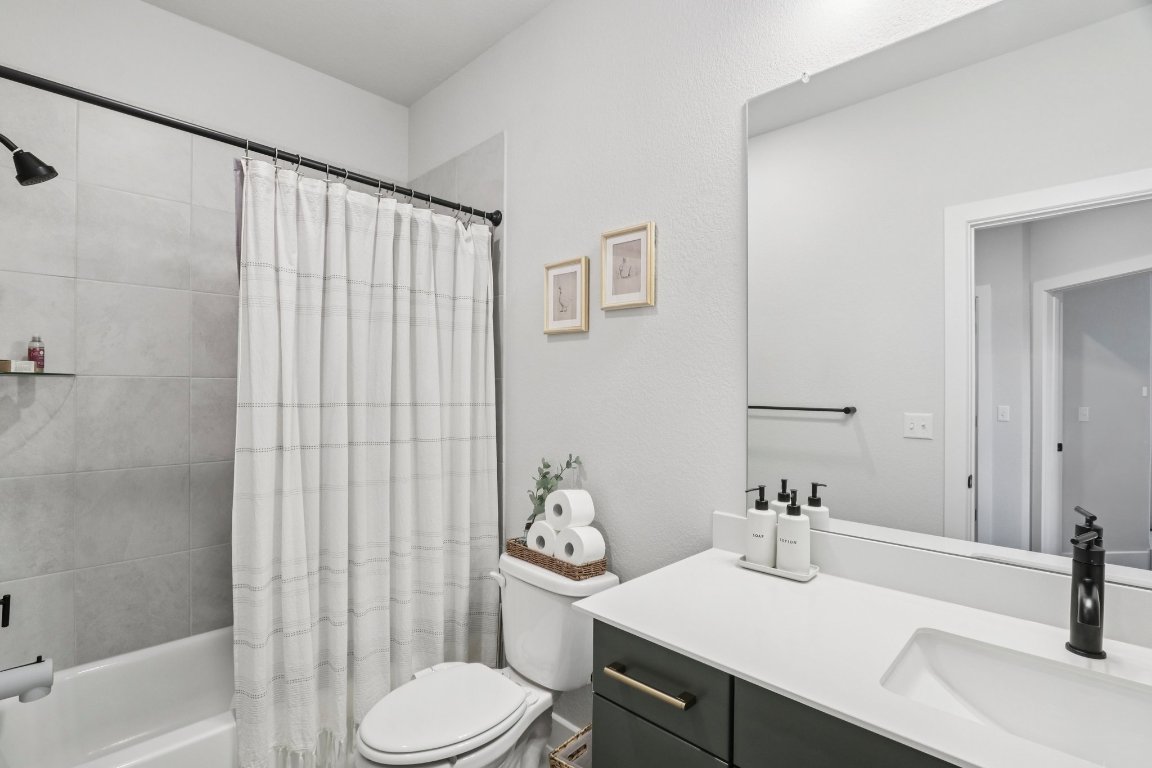 6001 McMurtry Street Austin, TX 78747 - Photo 18 of 26 a bathroom with a sink toilet and shower