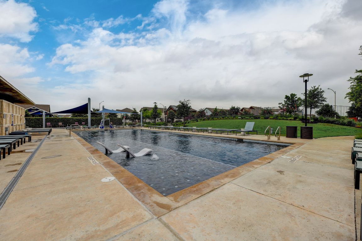 6001 McMurtry Street Austin, TX 78747 - Photo 23 of 26 a view of swimming pool with a yard