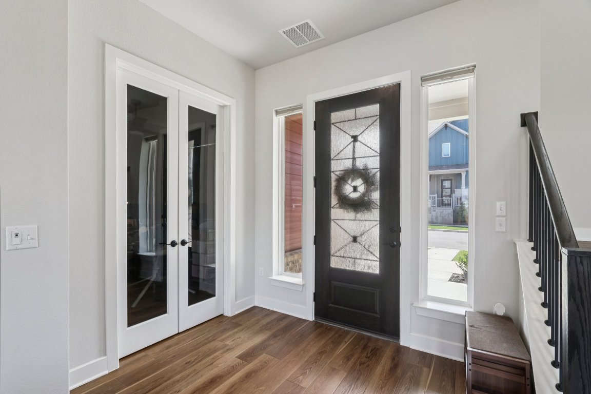 6001 McMurtry Street Austin, TX 78747 - Photo 4 of 26 a view of an entryway with wooden floor and a living room