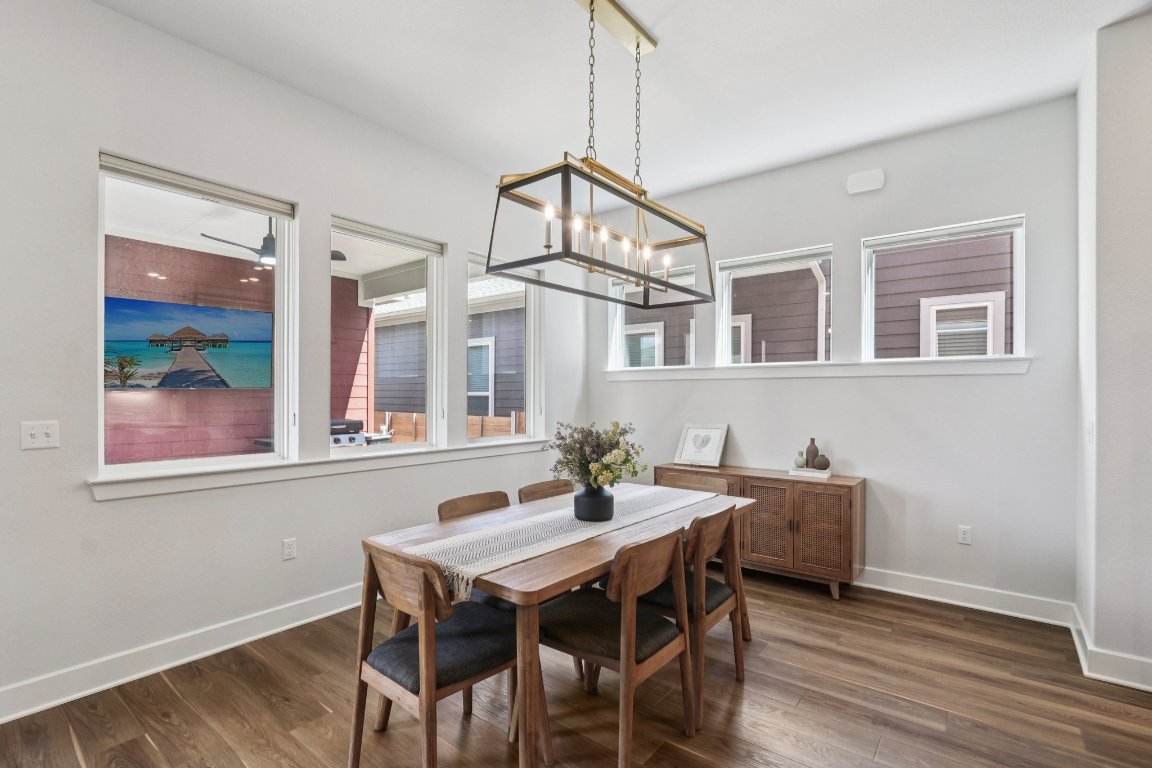 6001 McMurtry Street Austin, TX 78747 - Photo 8 of 26 a view of a dining room with furniture window and wooden floor