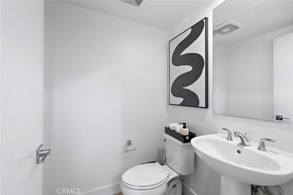 1826 West Bushell Street Anaheim, CA 92805 - Photo 22 of 30 a bathroom with a sink mirror and toilet