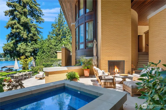 a balcony with wooden floor and outdoor seating