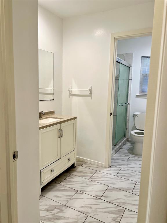 2529 Rutgers Drive Irving, TX 75062 - Photo 25 of 38 Bathroom featuring an ivory vanity with a light-toned countertop, rectangular sink, and tile flooring