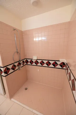 a picture of a bathroom with a shower