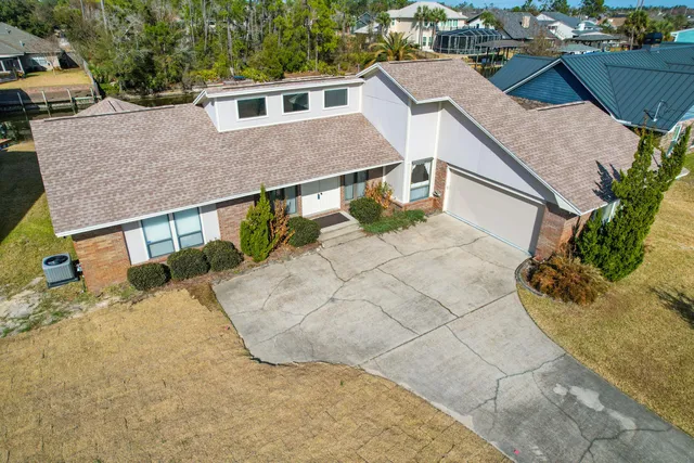 an aerial view of residential houses with outdoor space and swimming pool