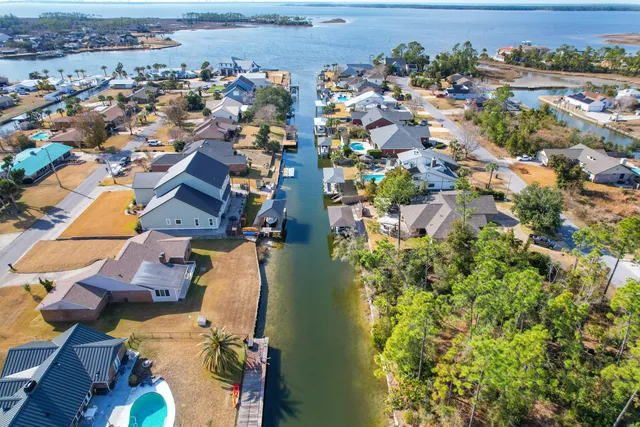 an aerial view of a city with ocean view in back