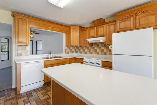 a kitchen with a sink a stove and cabinets