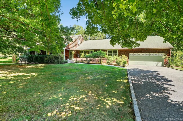 a view of a house with a yard and a fountain