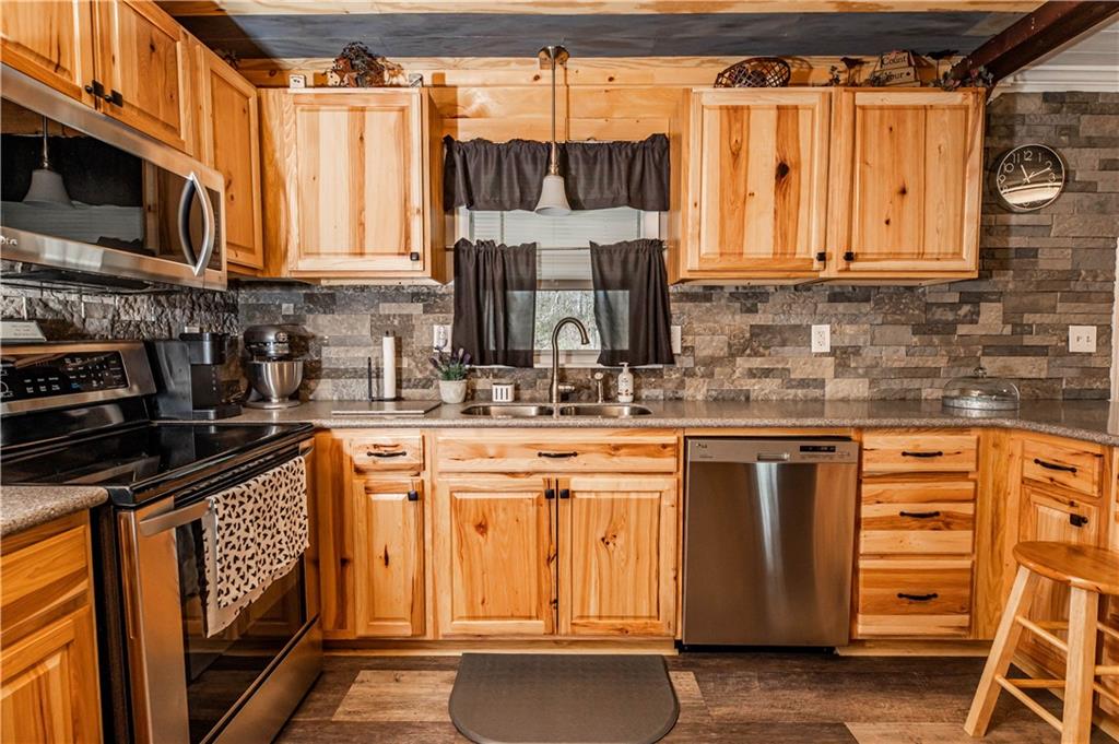 280 Chestnut Road Penn Run, PA 15765 - Photo 9 of 25 a kitchen with stainless steel appliances granite countertop a stove a sink and a microwave