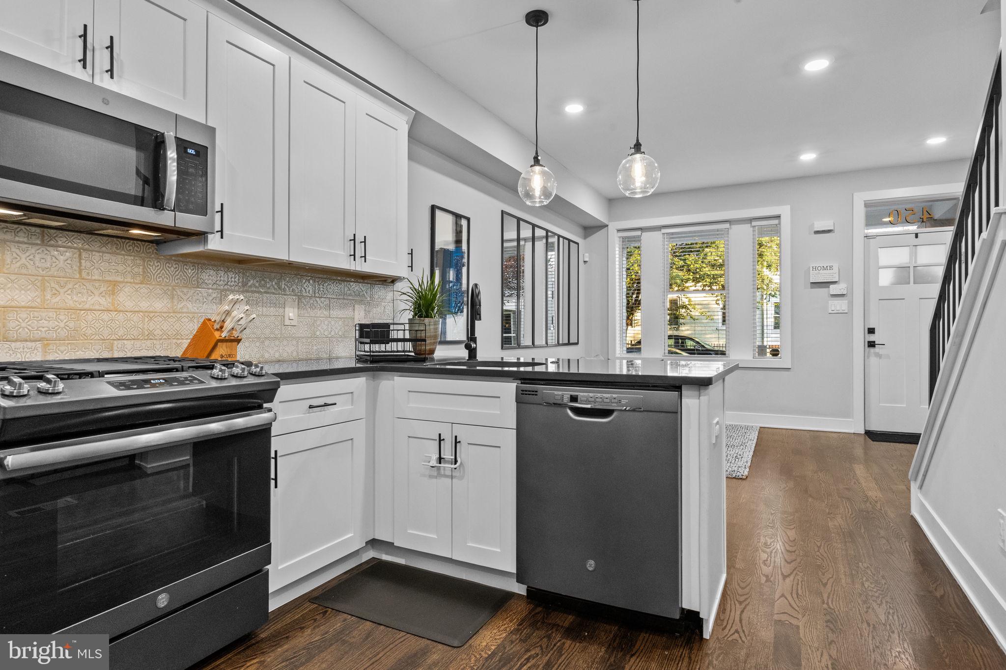 450 Ripka Street Philadelphia, PA 19128 - Photo 12 of 47 a kitchen with stainless steel appliances granite countertop a stove a sink and a microwave