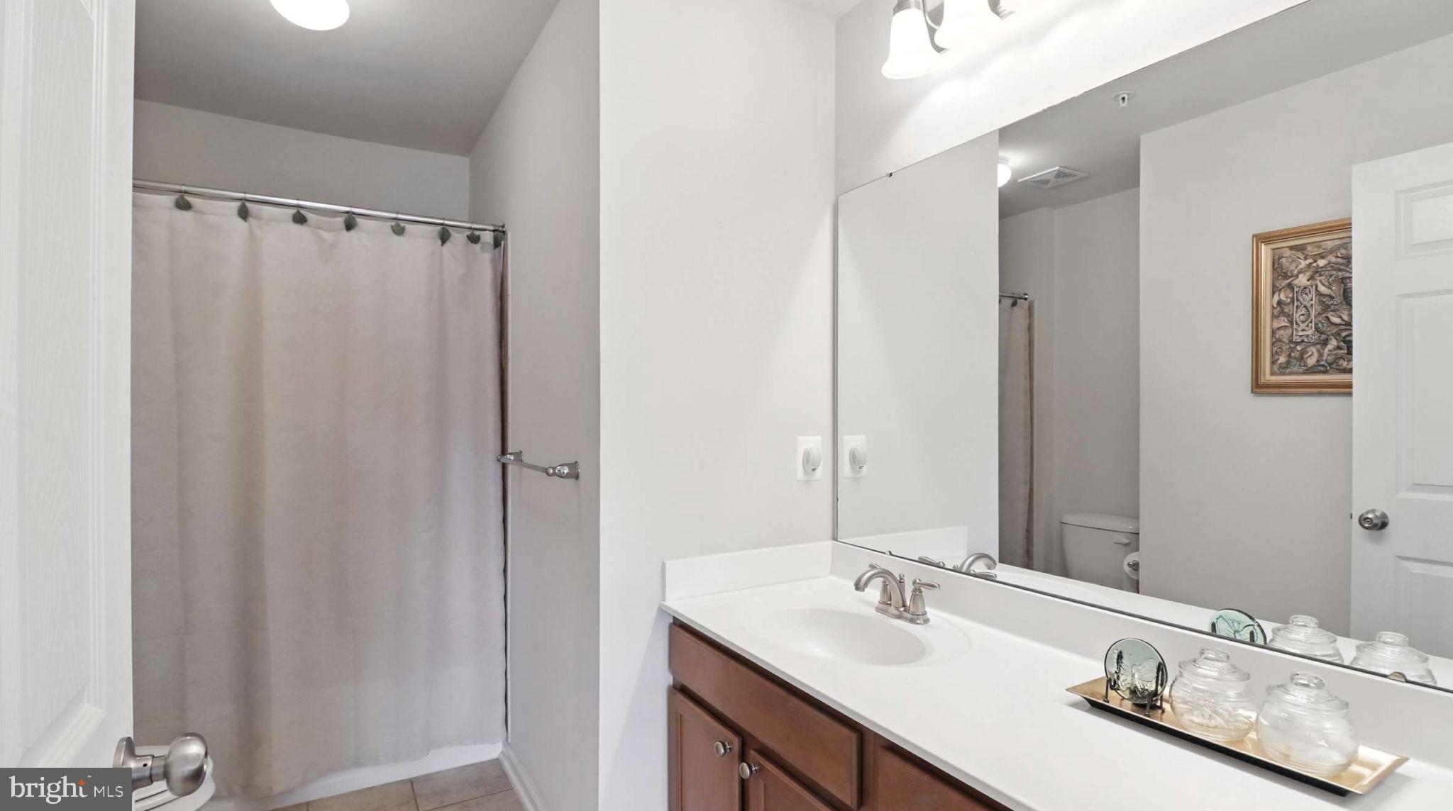 13511 Bermingham Manor Drive Laurel, MD 20708 - Photo 18 of 51 a bathroom with a double vanity sink and a mirror