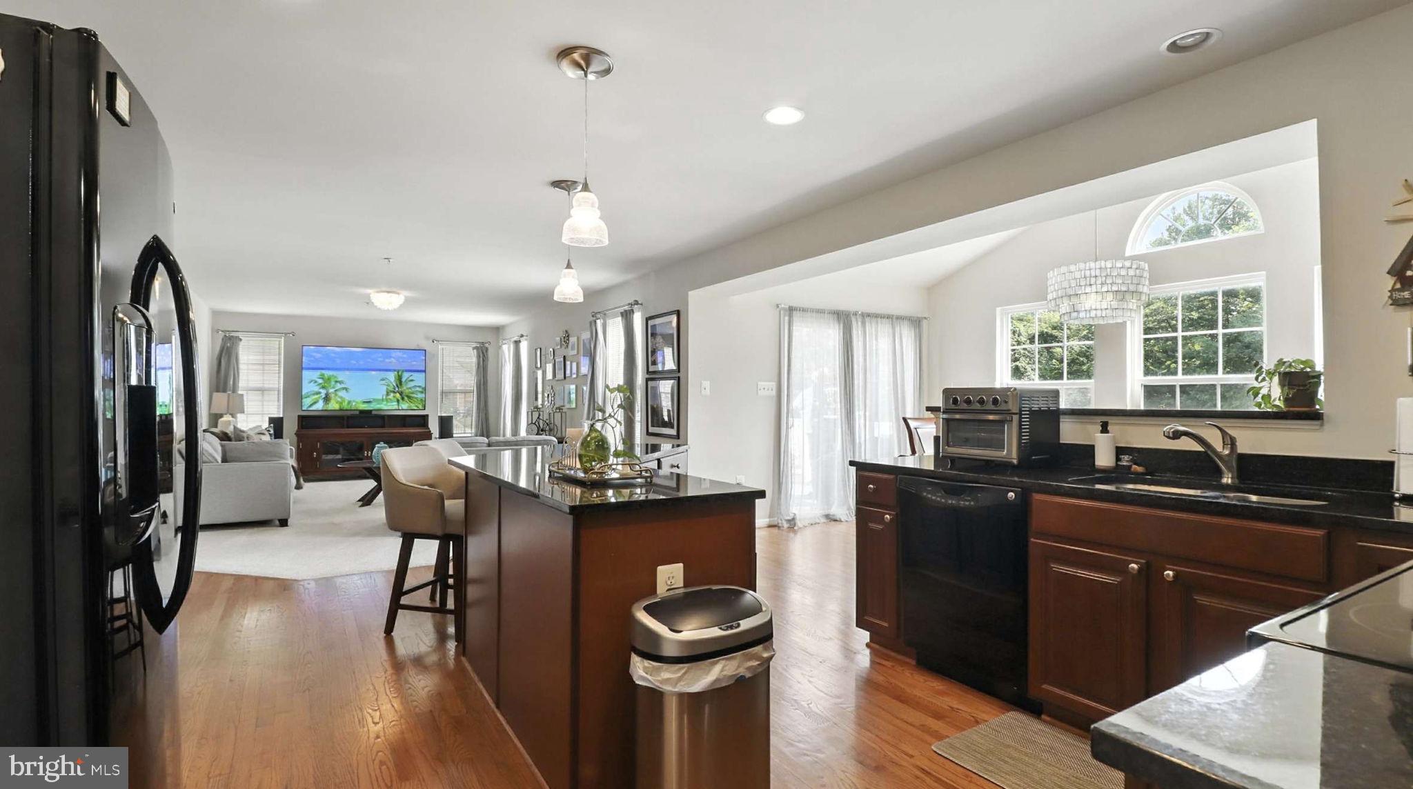 13511 Bermingham Manor Drive Laurel, MD 20708 - Photo 28 of 51 a kitchen with a table chairs refrigerator and cabinets