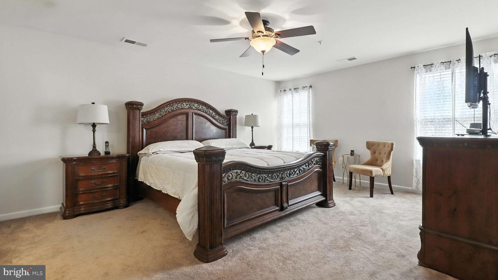 13511 Bermingham Manor Drive Laurel, MD 20708 - Photo 9 of 51 a spacious bedroom with a bed and a chandelier