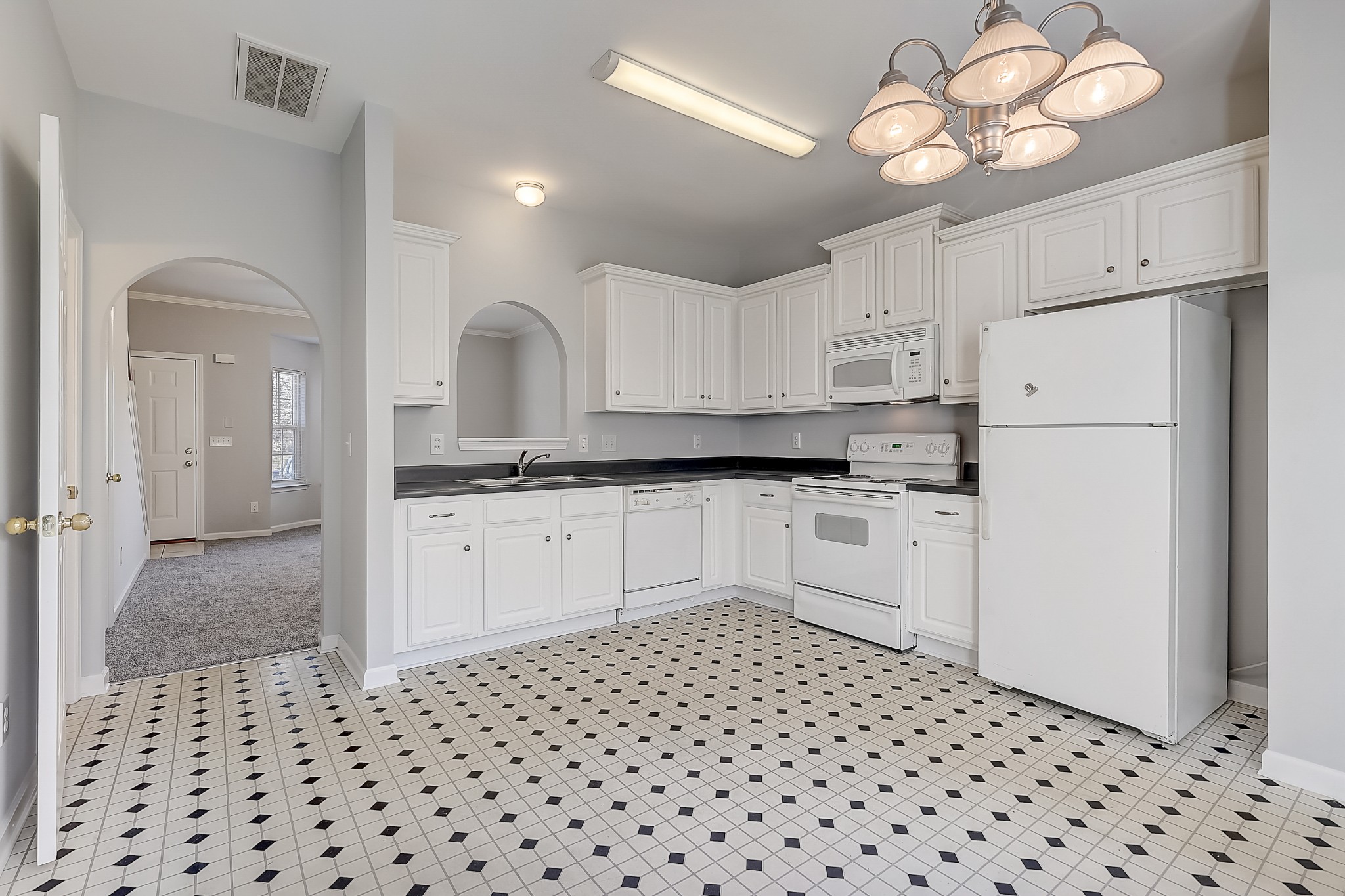 1101 Downs Boulevard, Unit 80 Franklin, TN 37064 - Photo 7 of 19 a kitchen with a refrigerator a stove top oven and cabinets