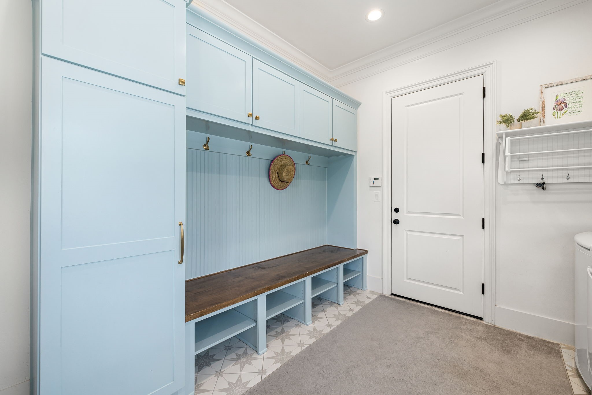 4311 Upper Oxbow Trace Fulshear, TX 77441 - Photo 16 of 49 Custom mudroom with built-in storage, bench seating, and stylish cabinetry designed for everyday functionality.