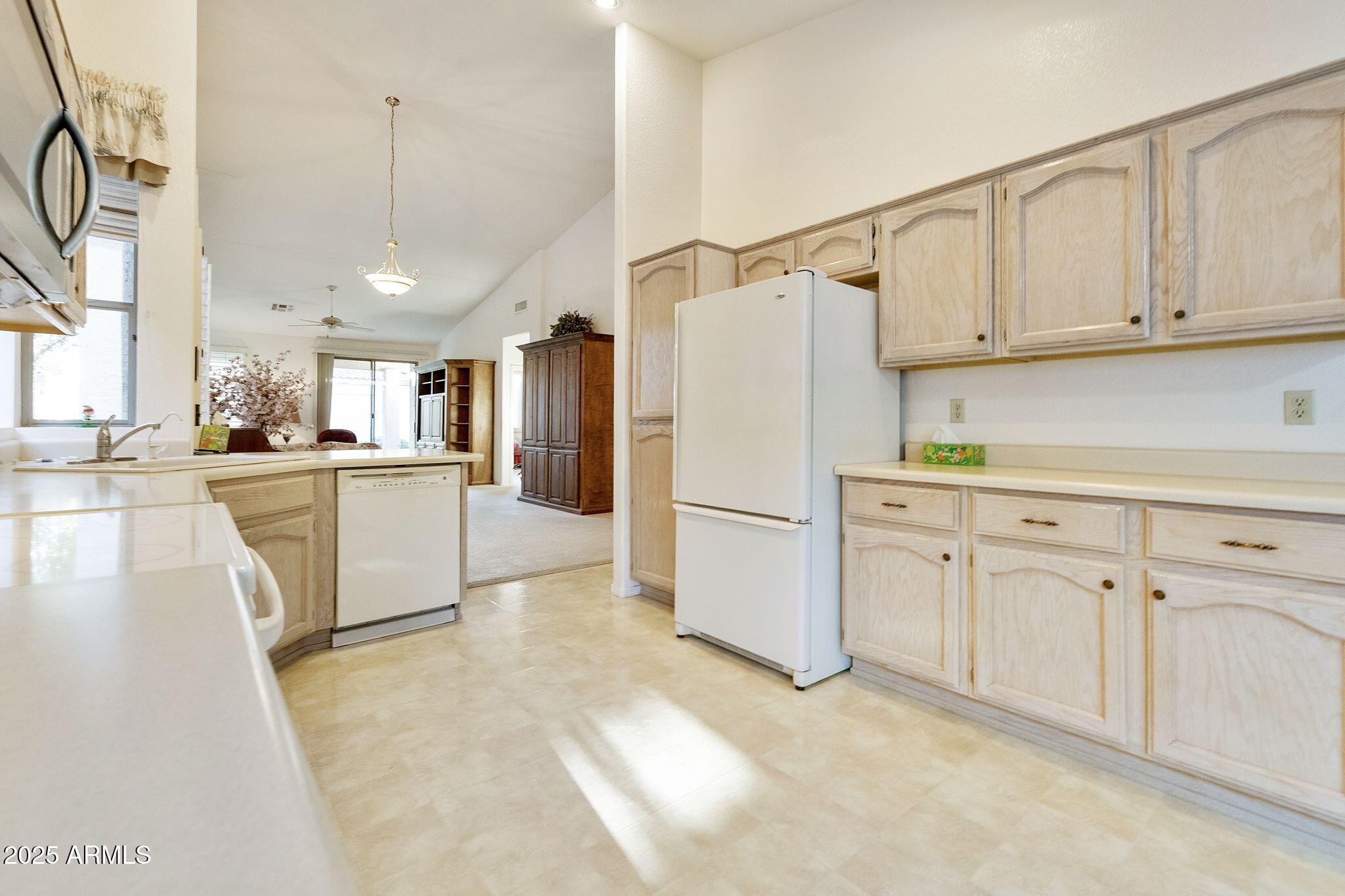 23729 South Pleasant Way, Unit 37 Sun Lakes, AZ 85248 - Photo 11 of 55 a kitchen with white cabinets and white appliances