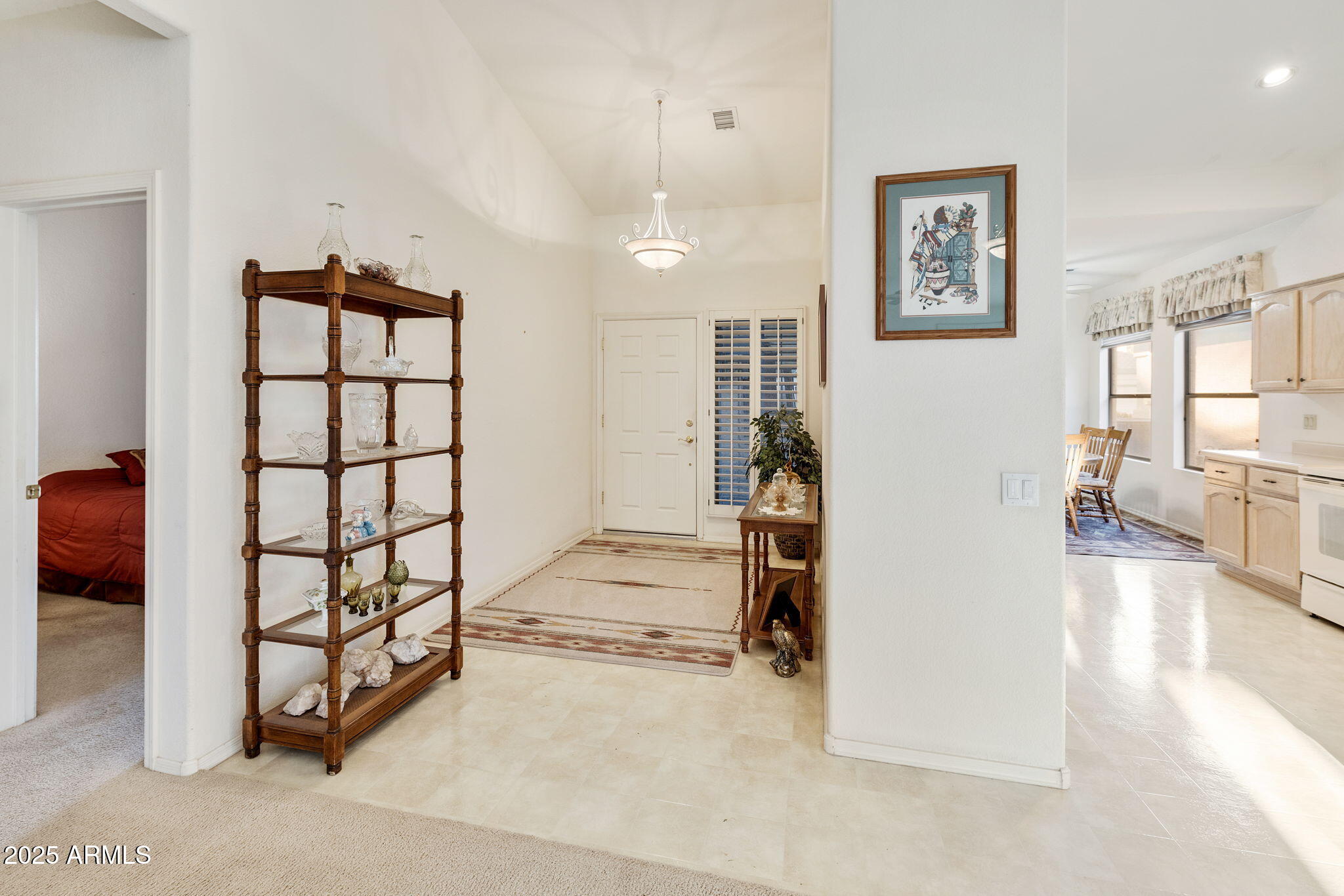 23729 South Pleasant Way, Unit 37 Sun Lakes, AZ 85248 - Photo 5 of 55 a view of a livingroom with wooden furniture and windows