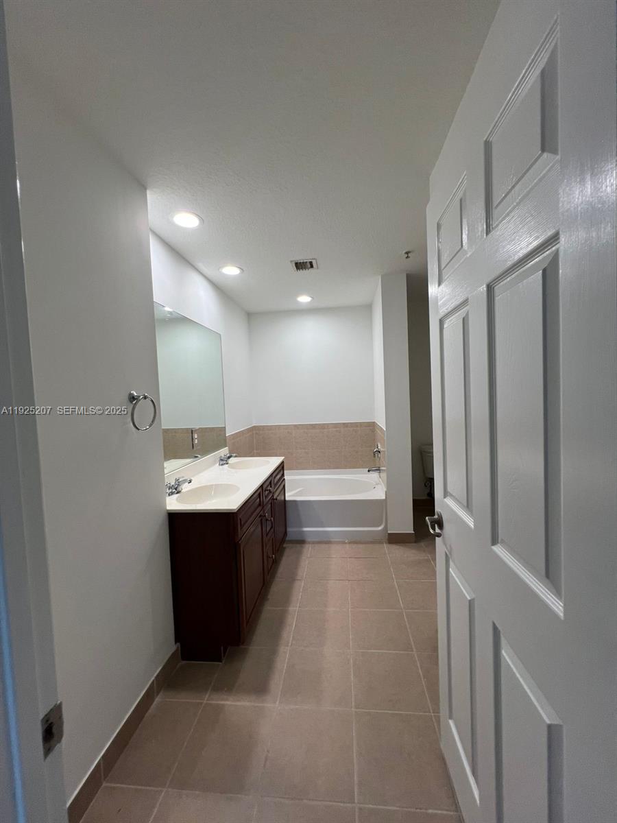 22 Southwest 6th Court, Unit 22 Pompano Beach, FL 33060 - Photo 15 of 26 a view of a bathroom with a sink and mirror