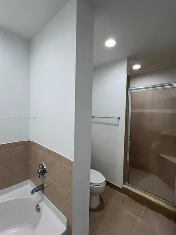 a bathroom with a toilet and a shower