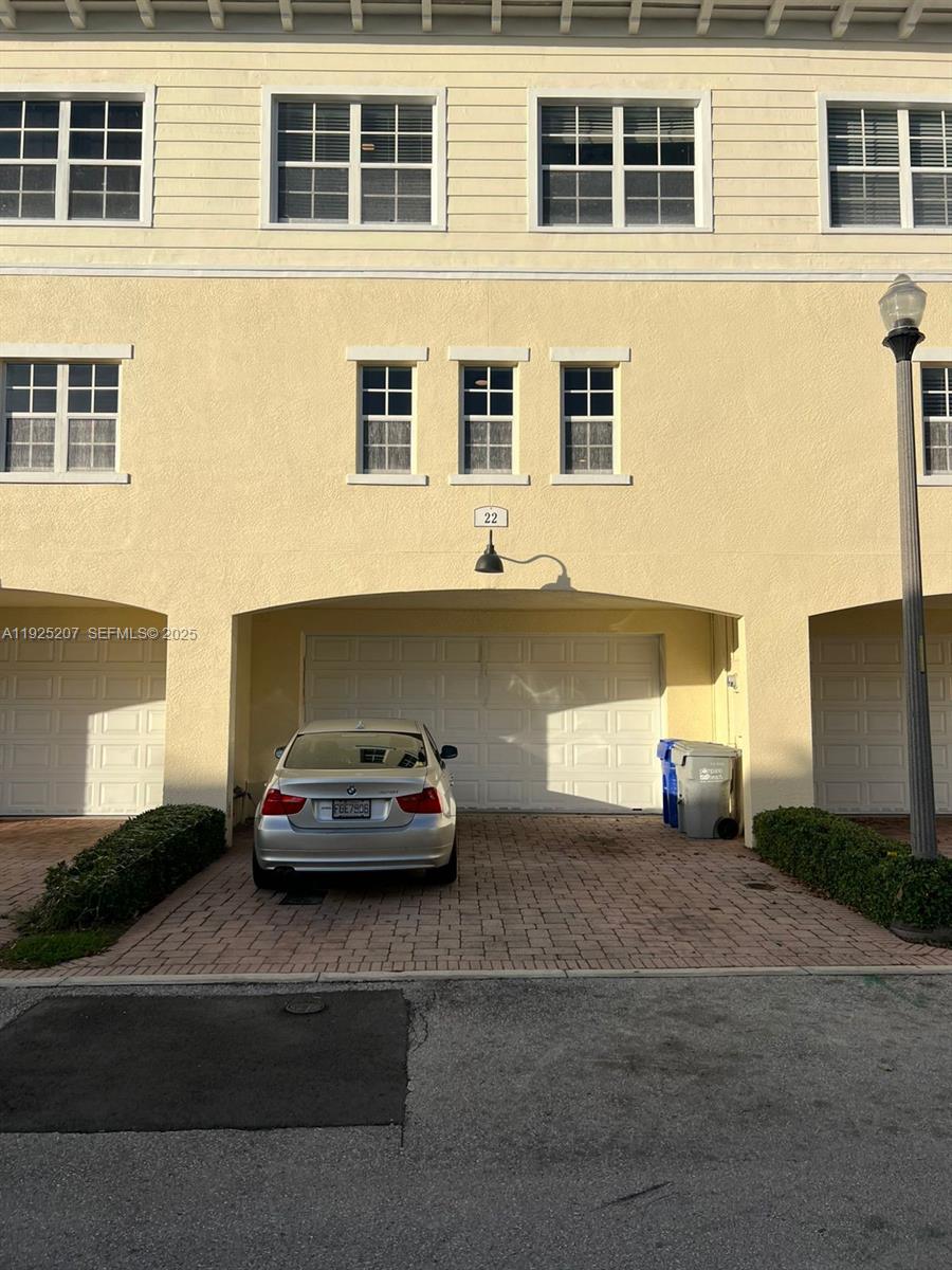 22 Southwest 6th Court, Unit 22 Pompano Beach, FL 33060 - Photo 25 of 26 a car parked in front of a building