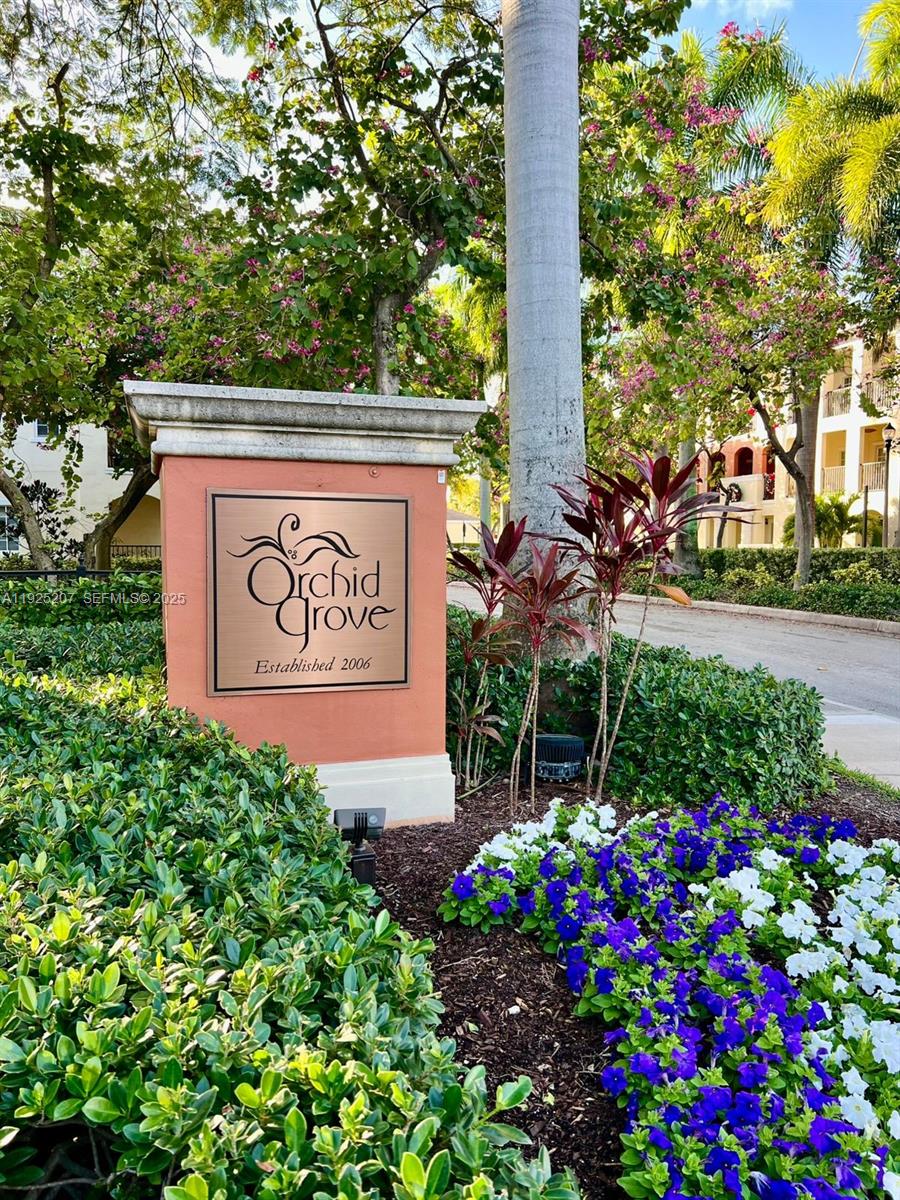 22 Southwest 6th Court, Unit 22 Pompano Beach, FL 33060 - Photo 26 of 26 a sign that is sitting in front of flowers