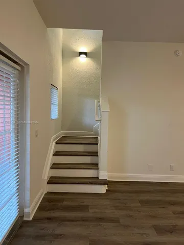 a view of entryway with wooden floor