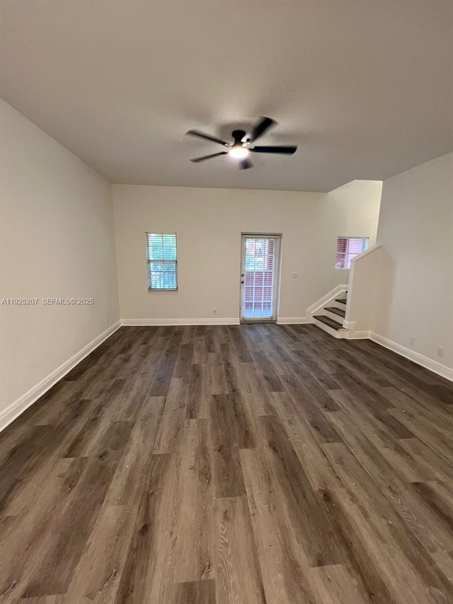 22 Southwest 6th Court, Unit 22 Pompano Beach, FL 33060 - Photo 5 of 26 a view of empty room with wooden floor and fan