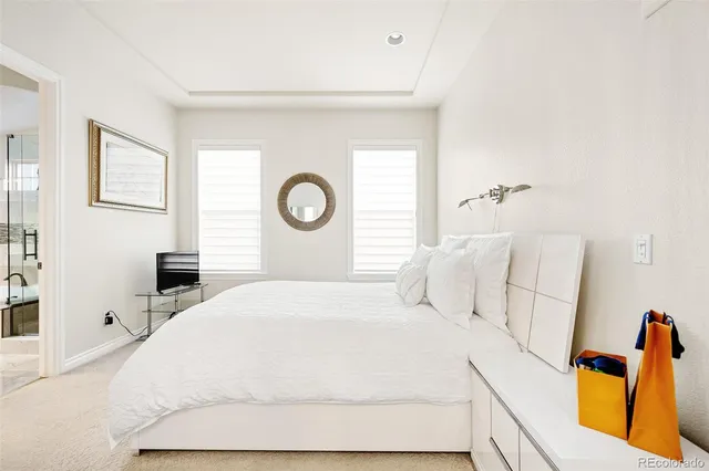 a bedroom with a bed and a lamp