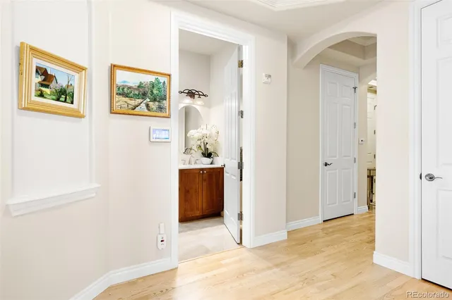 a view of a bedroom with wooden floor and hallway