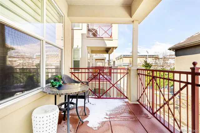 a view of a chairs and table in the balcony