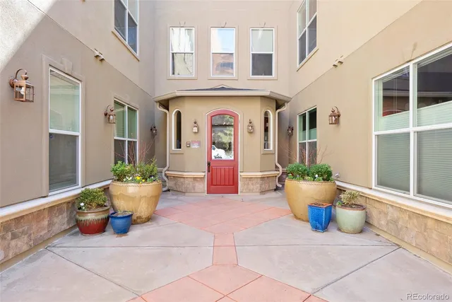 a view of a patio with dining space and glass windows