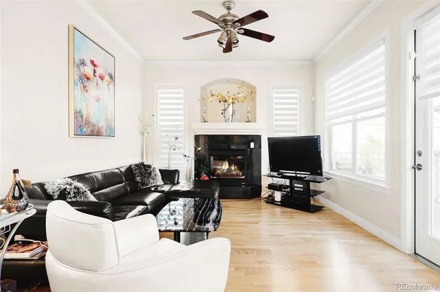 a living room with furniture a flat screen tv and a window