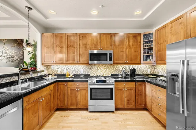 a kitchen with stainless steel appliances granite countertop counter space a sink and cabinets