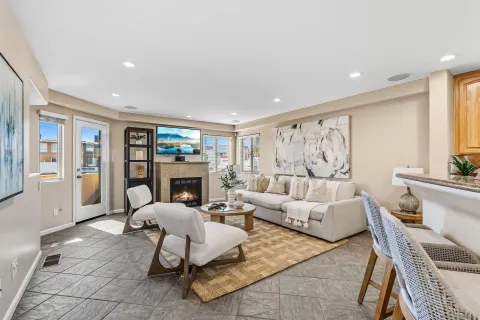 a living room with fireplace furniture and a large window