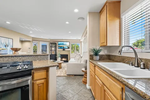 a kitchen with sink stove and cabinets