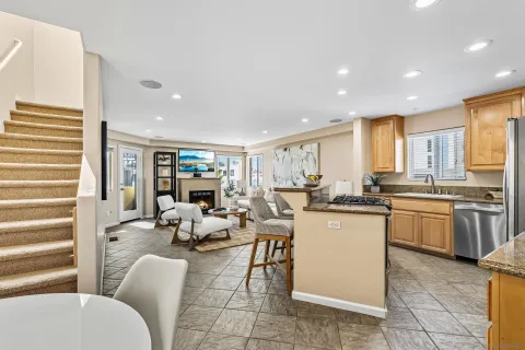 a kitchen with stainless steel appliances kitchen island granite countertop a sink and white cabinets