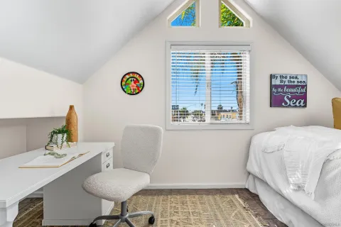 a bedroom with a bed and a desk