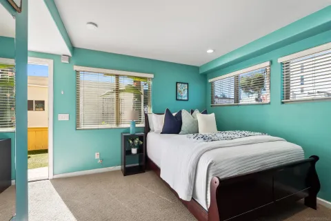 a bed sitting in a bedroom next to a window