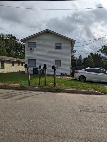 a front view of a house with a garden and plants