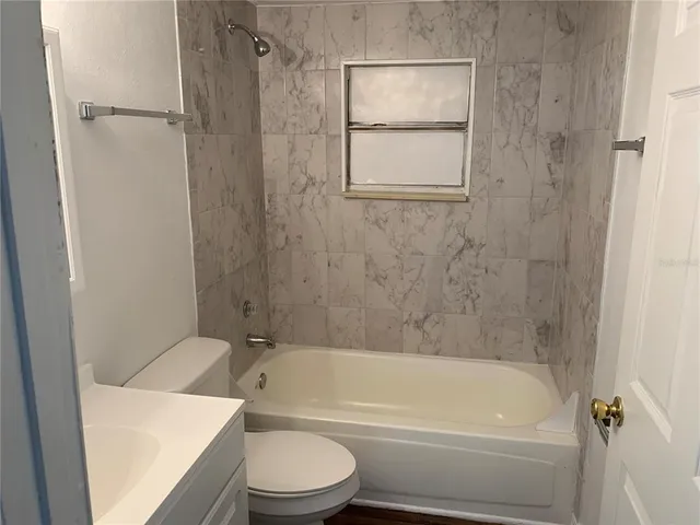 a bathroom with a toilet and a bathtub