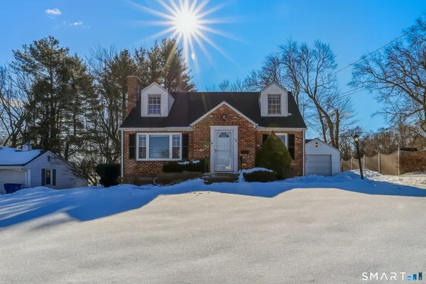 a view of a house with a yard covered in snow
